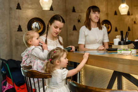 Russia, Gatchina, November 20212: Young mothers with children gathered to spend time in a barのeditorial素材