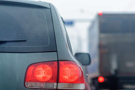 Rear side of cars on the road. Stop and open light brake with turn signal light.の写真素材