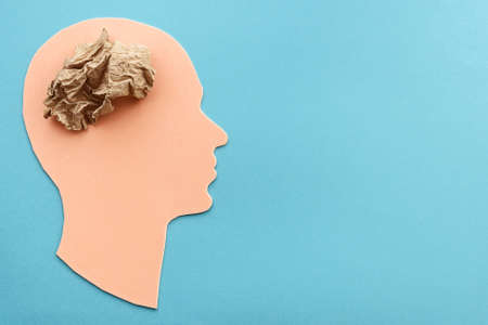 Head of a man with a paper brain. The concept of mental health and thinking.