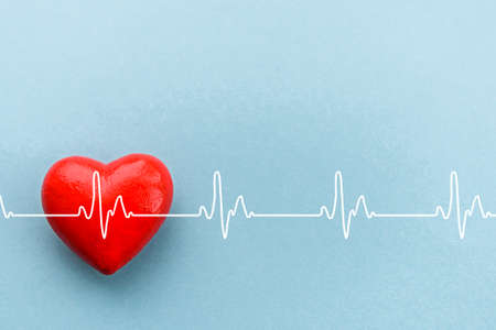 Red heart on a blue background. The concept of health, support, international or national Cardiology Day.の写真素材