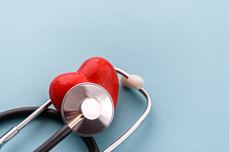 red heart with a stethoscope on a blue background. The concept of heart health, health insurance,...