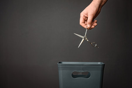Scissors are thrown into a bucket for recycling or recycling.の写真素材