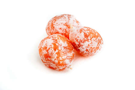 Dried kumquat in sugar isolated on a white background.の写真素材