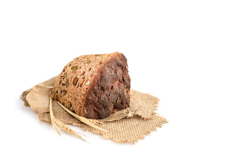 A slice of homemade grain bread on whiteの写真素材