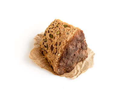 A slice of homemade grain bread on whiteの写真素材