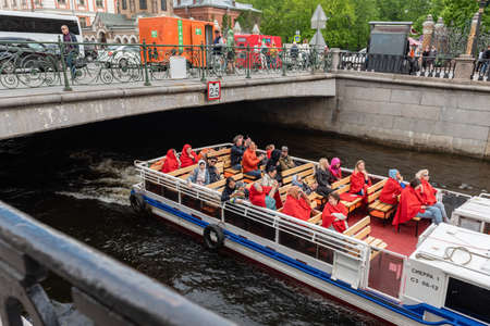 Russia, St. Petersburg, June 2022: pleasure boat with tourists on the canalのeditorial素材