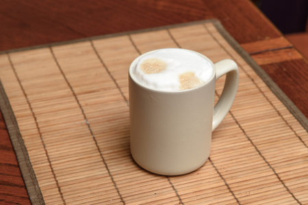 A cup of fresh coffee with cappuccino foam on the tableの写真素材