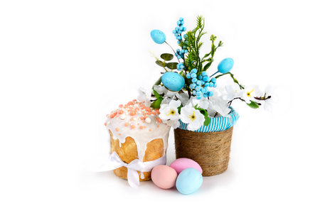 Delicious Easter cakes, eggs flowers in a basket on a white backgroundの写真素材