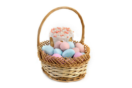 Delicious Easter cakes and eggs in a basket on a white background.の写真素材