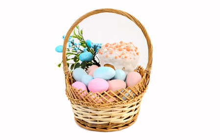 Delicious Easter cakes and eggs in a basket on a white background.の写真素材