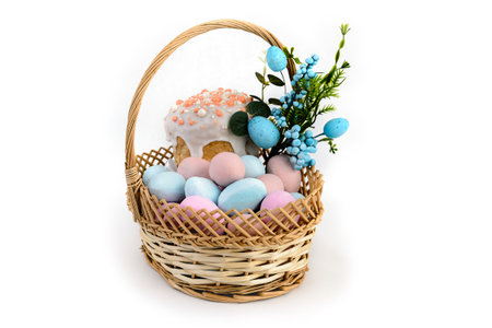 Delicious Easter cakes and eggs in a basket on a white background.の写真素材