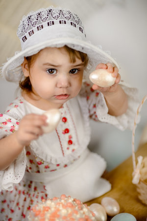 Little girl playing with Easter eggsの写真素材