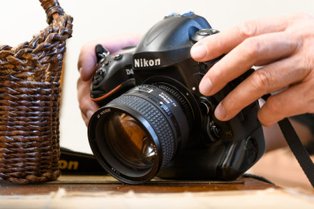 Russia, St. Petersburg, August 2023: Men's hands hold a Nikon 4D camera in close-upのeditorial素材
