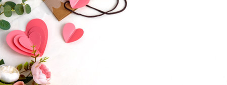 Background for Valentine's Day. Pink hearts and flowers on a light background. Flat layout and a place to copyの写真素材