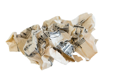A wad of crumpled music paper on white isolated background