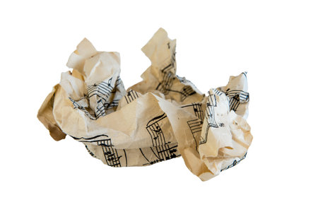 A wad of crumpled music paper on white isolated background
