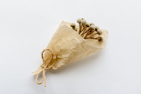 Vintage dry flower in paper bag on white background.