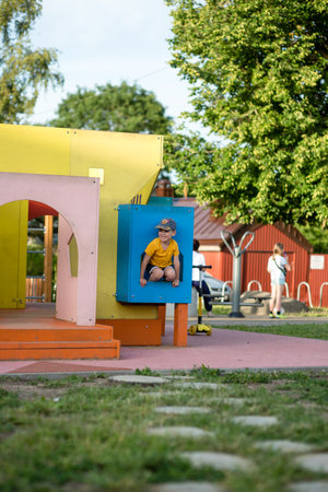 Young boy playing on a children's playground in the city park.の写真素材