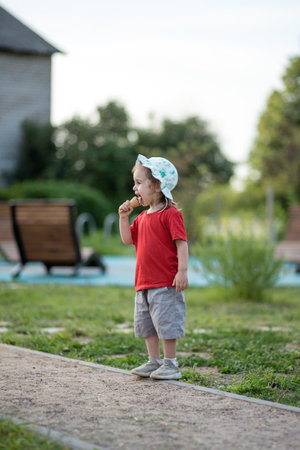 portrait of a child with ice cream in a parkの写真素材