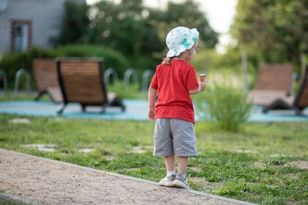 portrait of a child with ice cream in a parkの写真素材