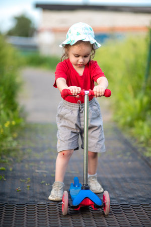 little girl on scooterの写真素材