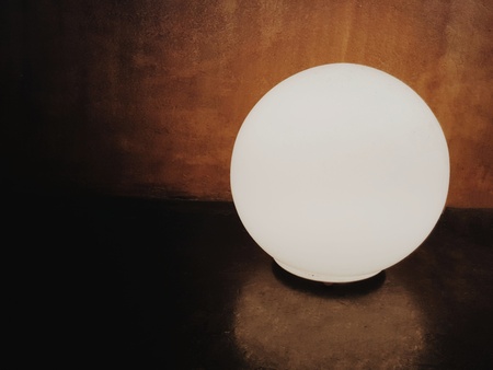 Light circular lamp in the dark room with the shadow reflection on the floorの写真素材