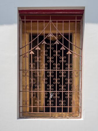 Iron fence color dark brown to prevent theft, Adjoining wood window, In temple name is Wat Arun Ratchawararam Woramahaviharn at Bangkok Thailandの写真素材