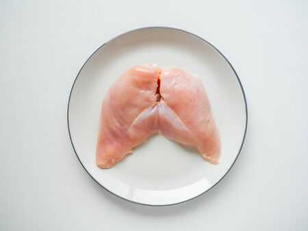 Fresh chicken breast Topping black pepper on dish Whiteの写真素材