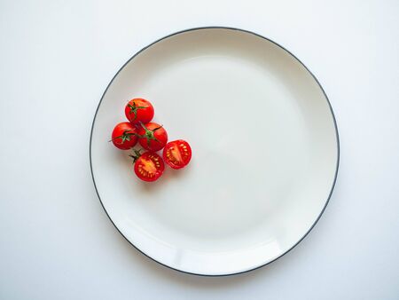 Red tomatoes Put on dish White, Food for healthy, white backgroundの写真素材