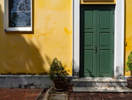 Thai architecture is influenced by Europe,Yellow wall And Green door Unique pattern of...