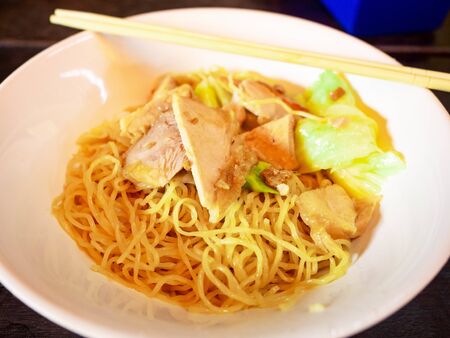 Pork noodle, noodles made from chicken eggs mixed with flour, made out to be boiled noodles, turning to pieces. Food of Chinese people living in Thailandの写真素材