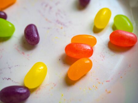 Candy Multicolored orange, green, purple, pink, yellow with a sour, fruity scent on a white dish.の写真素材