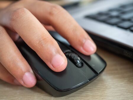 Woman's hand is pressing the Mouse,Work form home during the epidemic
