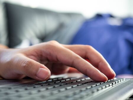 Woman's hand is pressing the keyboard,Work form home during the virus epidemicの写真素材