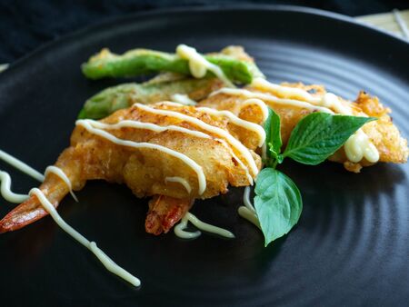 Batter Fried Shrimp and Yardlong beans fried Top with sauce face,The background is black fabric, Snack Crispy Friedの写真素材