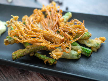 Yard long beans and mushrooms Dipped
fried,Eaten with a white sauce containing Garlic,Pepper Placed...