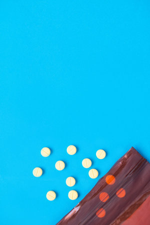 A pill that is poured out of the medicine bag There are many types of drugs used to treat various diseases. Blue backgroundの写真素材