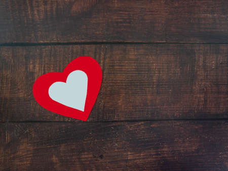 White hearts over red hearts on the wooden floor.の写真素材