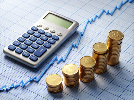 calculator and coins on graph paper, business and finance conceptの素材
