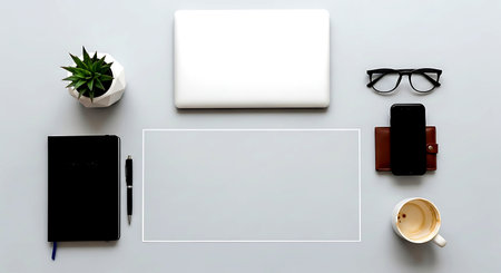 White office desk table with laptop, smartphone, notebook, pen and coffee cup. Top view with copy spaceの素材