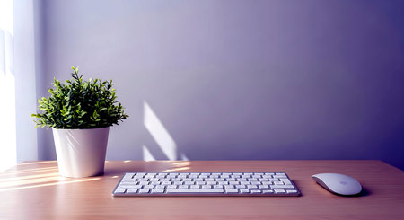 Computer keyboard, mouse and a plant in a vase on a wooden tableの素材