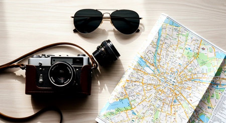 Travel accessories. Camera, map, sunglasses and map on wooden backgroundの素材
