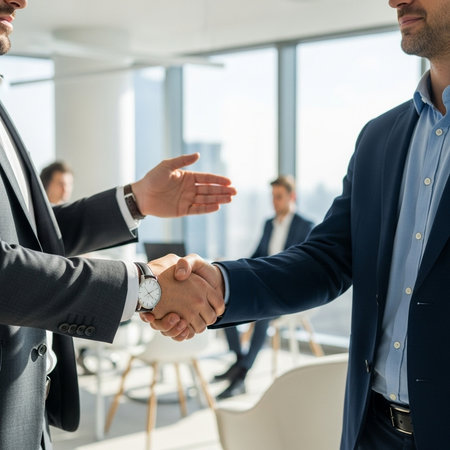 cropped shot of businessman shaking hands with colleague during meeting in officeの素材