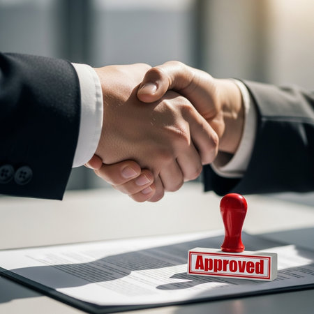 close up.businessman and businesswoman shaking hands after signing contractの素材