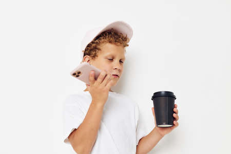 Cute little boy talking on the phone with a black glass light background unaltered