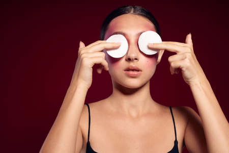 Portrait of beautiful young woman pink face makeup posing attractive look skin care close-up unalteredの写真素材