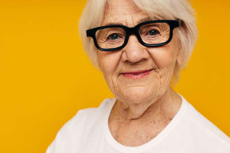 Portrait of an old friendly woman health lifestyle eyeglasses isolated backgroundの写真素材