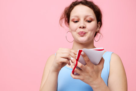 teenager girl learning with notebook and pen pink color background unalteredの写真素材