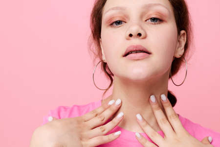 beautiful woman in a pink T-shirt Youth fashion pink color background unalteredの写真素材