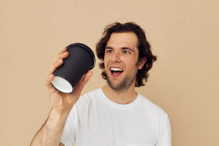 Cheerful man with a black glass in a white t-shirt isolated backgroundの写真素材